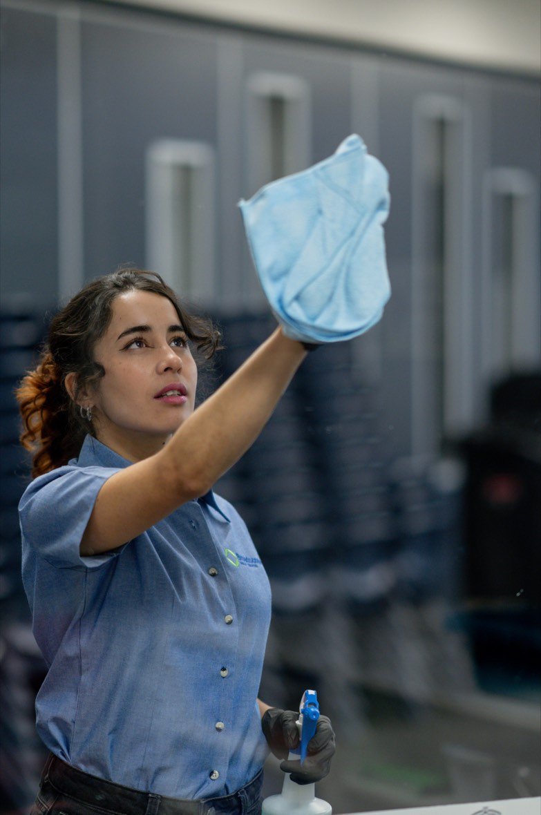Staff member wiping down a surface