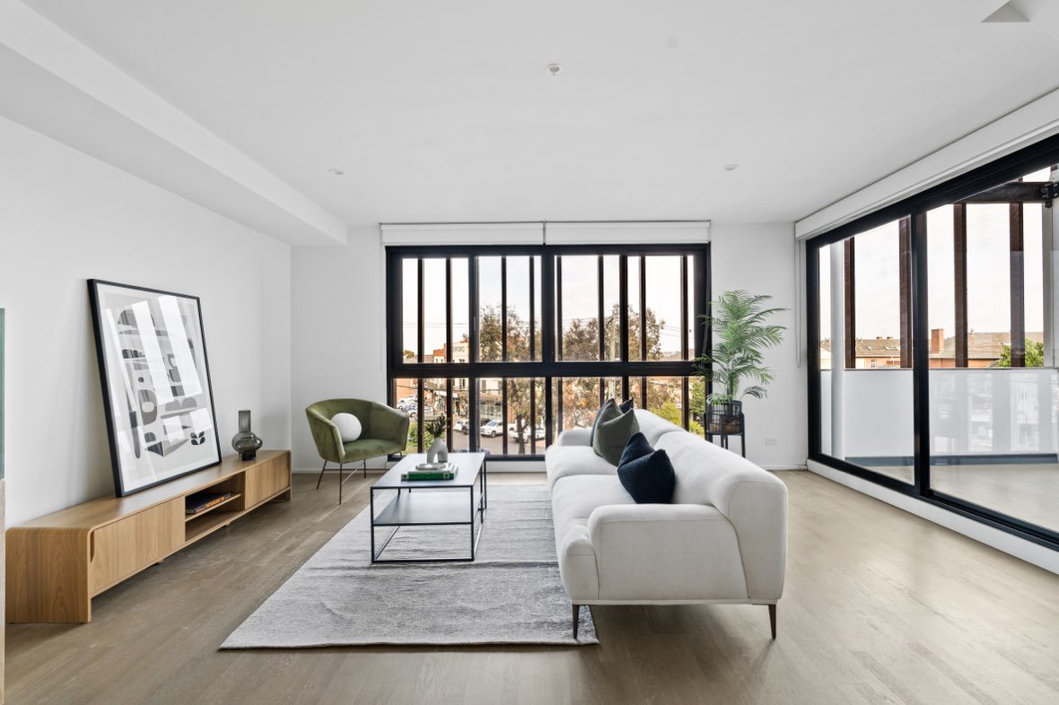 Light-filled modern living room with black-framed windows