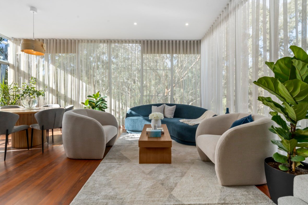 Living room with curved sofa and garden view