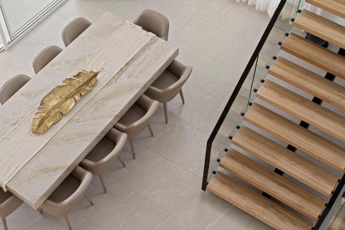 Marble dining table beside a timber staircase